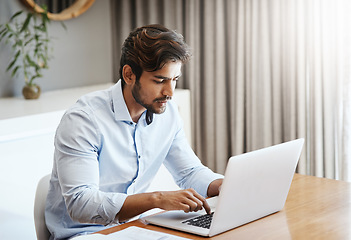 Image showing Serious man, remote work and typing on laptop in home at table for digital planning, research and online network. Focused male freelancer working on computer keyboard, internet technology and website