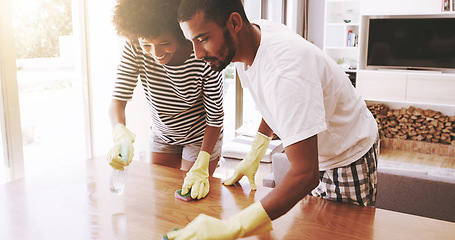 Image showing Spray, couple and cleaning table in home for housekeeping, maintenance and responsibility. Man, woman and wipe furniture surface with sponge, detergent and chemical of dust, bacteria and disinfection