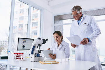 Image showing Scientist, tablet and teamwork in forensic science looking at experiment results or collaboration at laboratory. Woman and man in medical research working on technology for scientific research in lab