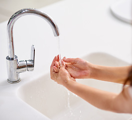 Image showing Tap, water and woman cleaning hands for skincare, beauty and safety of bacteria, virus and healthy dermatology at home. Closeup of person washing palm of hand at basin in bathroom for hygiene routine