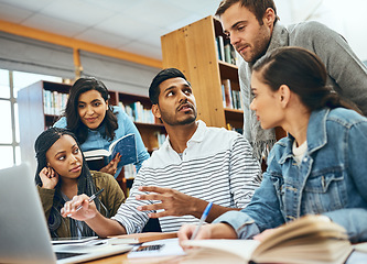 Image showing Education, talking and students studying in a library for a group project, teamwork and learning. Diversity, laptop and friends speaking about university notes, knowledge and planning research