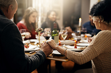 Image showing Food, thanksgiving and hand holding with family at table in dining room for holiday, prayer or worship. Celebration, support and gratitude with people praying at home for kindness, dinner and love