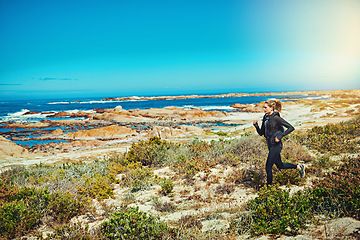 Image showing Woman running, beach and fitness outdoor with cardio and training for marathon with young athlete and sports. Female runner in nature, ocean and run for exercise with healthy person and mockup space