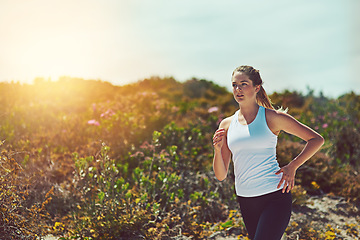 Image showing Woman running in nature, fitness outdoor with cardio and training for marathon with young athlete and sports. Female runner in bush, sunshine and run for exercise with healthy person and mockup space