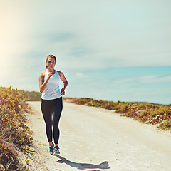 Image showing Woman running on road, fitness outdoor with cardio and training for race with athlete, sports and mockup space. Female runner in nature, blue sky and run for exercise with healthy and active person