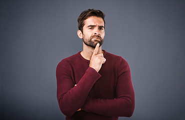 Image showing Doubt, thinking and portrait of man in studio with unsure, uncertain and thoughtful on gray background. Confused, mockup space and face of male person skeptical for decision, choice and question