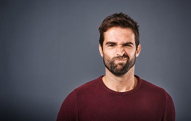 Image showing Doubt, confused and portrait of man in studio with unsure, uncertain and thoughtful on gray background. Thinking, mockup space and face of male person skeptical for decision, choice and question