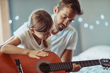 Image showing Man, girl and kid in guitar teaching and learning at home, bonding with love and creativity. Family, father and daughter learn to play musical instrument, focus in lesson and music education help