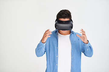 Image showing Man, vr and and futuristic technology on mockup standing amazed against a white studio background. Male in virtual reality, metaverse or future innovation with digital headset on mock up space