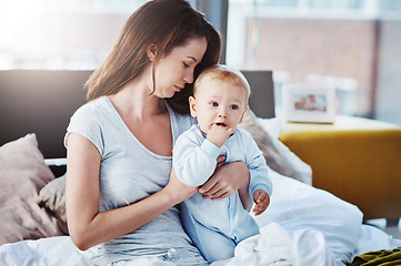 Image showing Mother, baby and morning in bed with care, support and love for newborn boy, calm mama and together in home. Mom, child and peace in motherhood, childcare and tired postpartum parent or hug infant