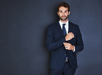 Image showing Portrait, mockup and a formal business man in studio on a blue background for corporate fashion on mock up space. Success, professional and confident young male employee in a suit for executive style