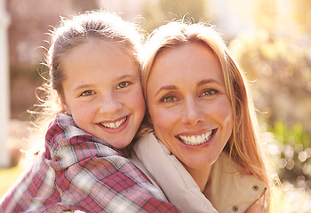 Image showing Face portrait, hug and happy mother, children or family smile, bonding and spending outdoor time together. Mothers day, faces of daughter and smiling woman, youth child or young girl hugging mom