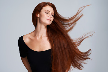 Image showing Hair, beauty and woman in studio with wind for keratin treatment, wellness and haircare on gray background. Salon, hairdresser and face of ginger female model for shine, healthy and natural hairstyle