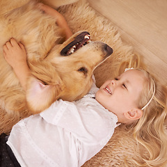 Image showing Dog, girl and hug together on floor in living room and golden retriever, kid and playing with pet on lounge carpet. Young child, labrador and happiness or family home, pets and children from above