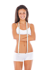 Image showing Happy woman, portrait and arms crossed with tape measure for lose weight or diet against a white studio background. Isolated fit or slim female model in underwear smiling for healthy body or wellness