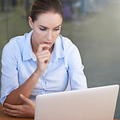 Image showing Business, serious woman and thinking face at laptop for research ideas, planning solution and online decision. Focused female worker at computer for insight, reading email and review tech information