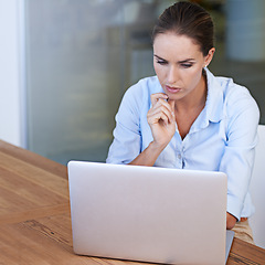 Image showing Business woman, thinking and serious at laptop to research ideas, brainstorming solution and online planning. Focused female worker at computer for decision, analysis or reading information at mockup