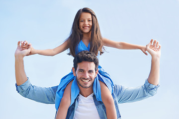 Image showing Blue sky, piggyback and happy family portrait of father, child or people having fun, playing outdoor game and bonding. Shoulder ride, summer sunshine and relax kid and dad smile for peace and freedom