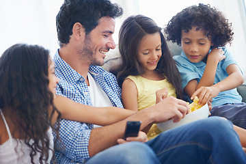 Image showing Happy family, relax father and children with food, eating meal and hungry while watching tv, film or home entertainment. Bonding, snack and youth kids, dad or group enjoy quality time together