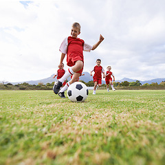 Image showing Running, kick and sports with children and soccer ball on field for training, competition and fitness. Game, summer and action with football player on pitch for goals, energy and athlete