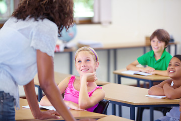 Image showing Teaching, woman teacher and happy children in education, support and helping for learning development in classroom. Listening, knowledge and school expert with girl and kids talking or advice on test