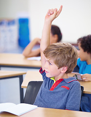 Image showing Classroom, child and raise hand for questions, support and help with education and teaching in school or classroom. Young boy or kid with arm up for knowledge, learning and class answer or advice