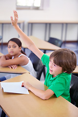 Image showing Child raise his hand in school for questions, support and help with classroom education and teaching in school development. Clever boy or kid with arm up for knowledge, learning and answer or advice