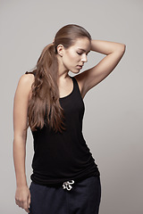 Image showing Fashion, casual and woman in a studio with fitness apparel, outfit or clothes and confidence, isolated on grey studio background. Pose, natural beauty and female model with cool style or athleisure