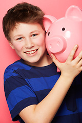 Image showing Happy boy, portrait and piggy bank with smile for savings, money or coins against a pink studio background. Little child or kid holding piggybank and smiling for financial freedom, cash or investment