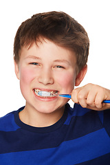 Image showing Face, smile and kid brushing teeth in studio isolated on a white background. Portrait, boy and child with toothbrush for oral health, hygiene and dental wellness, fresh breath and cleaning gums.