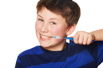 Image showing Portrait, smile and kid brushing teeth in studio isolated on a white background. Face, boy and child with tooth brush for oral health, hygiene and dental wellness, fresh breath and cleaning gums.