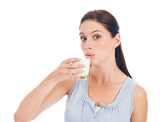 Image showing Drink up. Portrait, studio and woman drinks glass of milk for healthcare benefits, bone health or wellness hydration. Calcium dairy product, nutritionist face and model isolated on white background.
