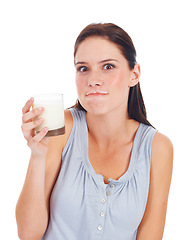 Image showing Portrait, funny woman and glass of milk for vitamin D healthcare benefits, bone health or nutritionist hydration drink. Calcium dairy product, wellness and studio model isolated on white background