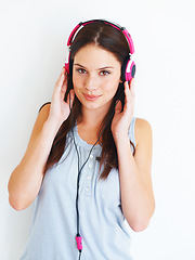 Image showing Music headphones, portrait and woman listening to fun girl song, wellness audio podcast or radio sound. Studio smile, happy freedom and gen z model streaming edm playlist isolated on white background