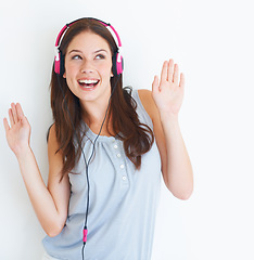 Image showing Music headphones, dance and happy woman listening to fun dancing song, wellness audio podcast or radio sound. Studio dancer, excited energy girl and model streaming edm isolated on white background