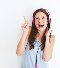 Image showing Music headphones, pointing and happy woman listening to girl song, audio podcast or radio sound. Mockup gesture, studio freedom and excited model streaming edm playlist isolated on white background