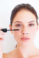 Image showing Beauty, makeup and portrait of woman with mascara in studio for volume or grooming on white background. Face, eyelashes and girl model with lash, brush or tool, luxury and cosmetics product isolated