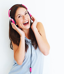 Image showing Music headphones, excited and happy woman listen to fun girl song, wellness audio podcast or radio sound. Studio smile, freedom and gen z model streaming edm playlist isolated on white background