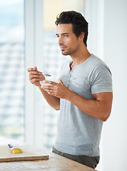 Image showing Wellness, breakfast and man eating a fruit salad for lunch or a healthy meal in his kitchen. Nutrition, diet and male person enjoying a organic, natural and vitality health food in his modern house.