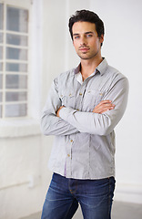 Image showing Power, man and arms crossed with serious face or male boss or employer with pride and white wall indoor. Vision, leadership and portrait of manager or entrepreneur and at workplace in Italy