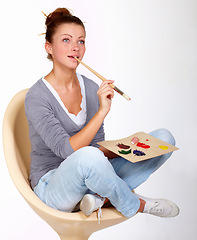 Image showing Thinking, painting and art ideas in studio for creativity, talent and a paint brush for color. Female artist or painter person isolated on a white background for creative work or project to relax