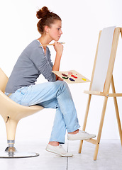 Image showing Woman, painting and thinking about art canvas in studio for creativity and talent with paint brush for color. Female artist or painter isolated on a white background for creative work and ideas