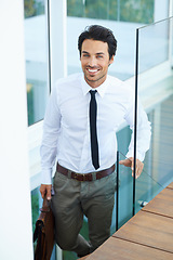 Image showing Happy, corporate and professional with a business man on stairs in a modern at work for progress. Smile, staircase and promotion with a handsome young male employee walking into his workplace