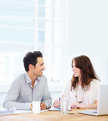 Image showing Planning, meeting and business woman with partner talking, collaboration and onboarding, teamwork and b2b communication. Happy people with paperwork, documents and laptop in office for discussion