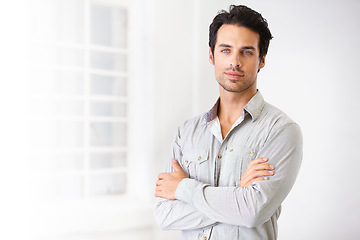 Image showing Portrait, man and real estate agent with arms crossed, pride for career or job with mockup. Face, serious and male realtor, entrepreneur and confident professional from Spain standing in home.