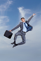 Image showing Business man, heel click and sky with suit, happiness and freedom for success, goal or outdoor for celebration. Young entrepreneur, businessman and dancer with excited jump, comic portrait and clouds
