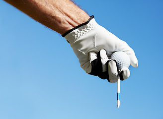 Image showing Golf ball, tee and hands of man on blue sky for contest, competition challenge and summer training on mockup. Closeup, gloves and golfer holding pin for action, games and outdoor gear for sports