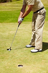 Image showing Ball, hole and man on golf course to aim for target, winning and training in contest, competition and challenge. Closeup of athlete, golfing club and action on grass for summer sports, games and gear