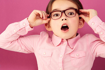 Image showing Portrait, shocked and girl child with glasses in studio isolated on a pink background. Kid, nerd and face of surprised person, wow or omg, emoji or reaction to unexpected news, announcement or secret