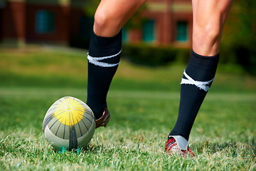 Image showing Rugby, feet and man with a sports ball outdoor on a pitch for action, goal or score. Male athlete person playing in sport competition, game or start training for fitness, workout or kick exercise